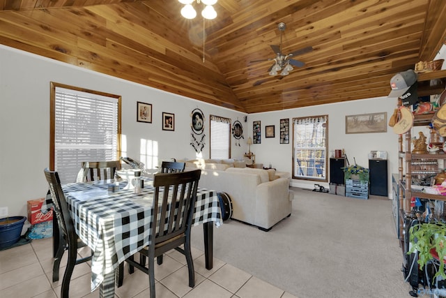 dining area featuring ceiling fan, light colored carpet, high vaulted ceiling, and wooden ceiling