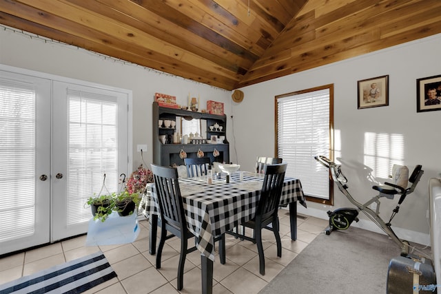 tiled dining space with a healthy amount of sunlight, french doors, and vaulted ceiling