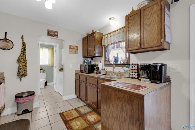 kitchen featuring sink and light tile patterned flooring