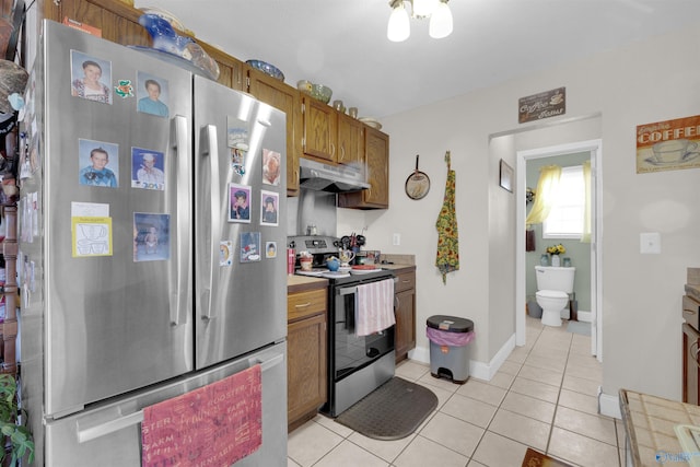 kitchen featuring light tile patterned floors and stainless steel appliances