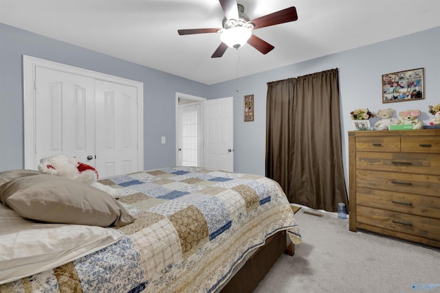 bedroom featuring light carpet, ceiling fan, and a closet