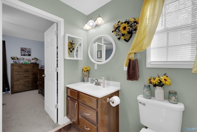 bathroom featuring toilet and vanity