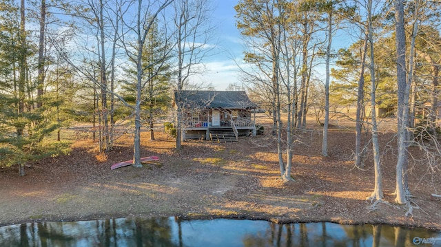 rear view of house with a deck with water view