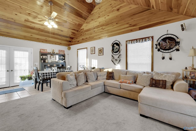 tiled living room with high vaulted ceiling, wood ceiling, and a wealth of natural light