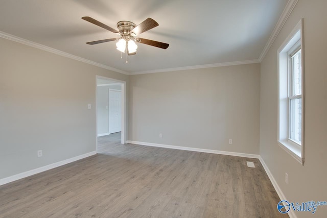 spare room with crown molding, light hardwood / wood-style floors, and a healthy amount of sunlight