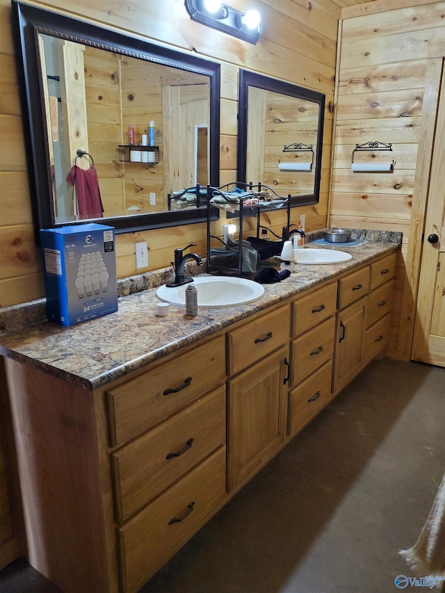 bathroom with double vanity, a sink, and wooden walls