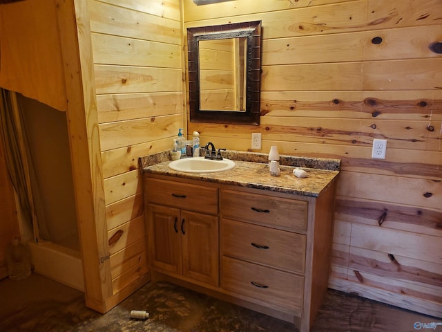 bathroom featuring wood walls and vanity