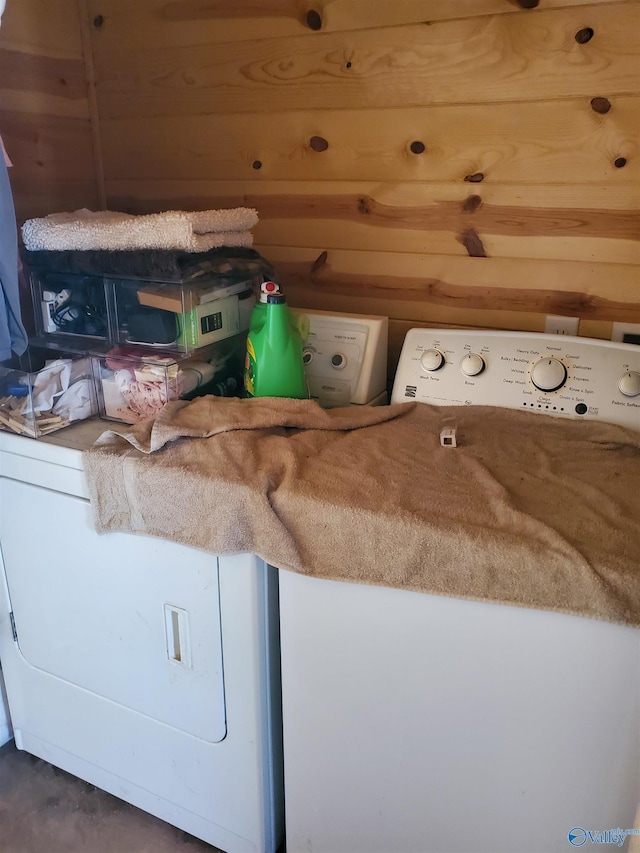 laundry room featuring laundry area, independent washer and dryer, and wooden walls