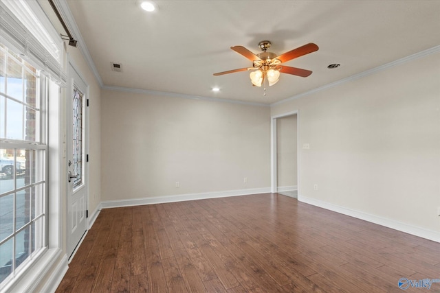 spare room with ceiling fan, ornamental molding, and dark wood-type flooring