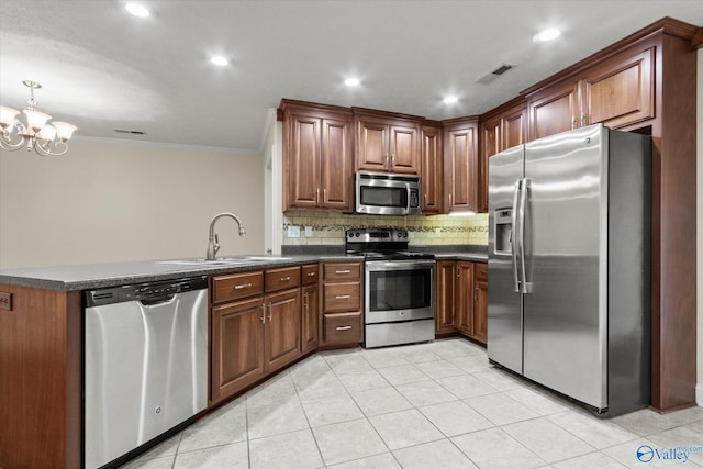 kitchen featuring an inviting chandelier, backsplash, appliances with stainless steel finishes, ornamental molding, and sink