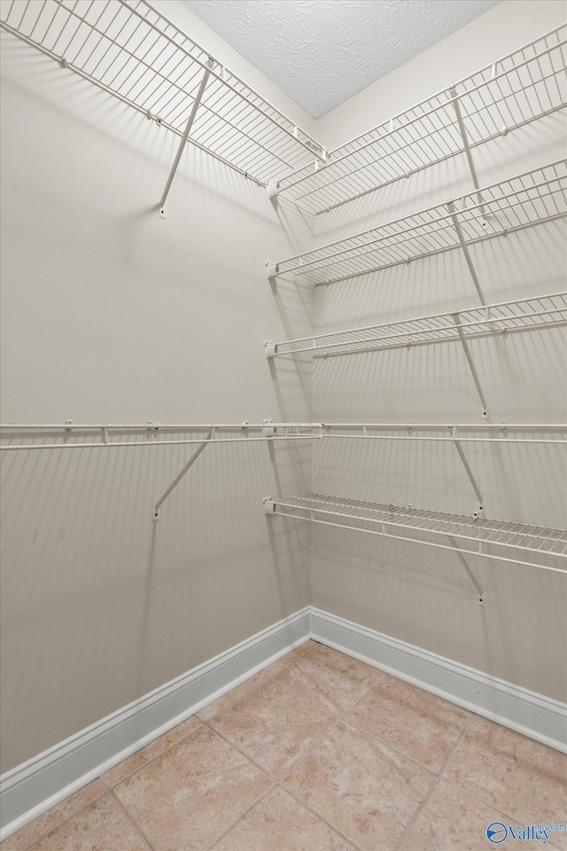 spacious closet with tile patterned flooring