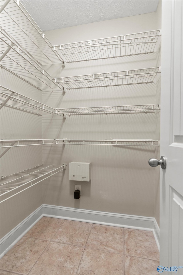 laundry area with tile patterned floors