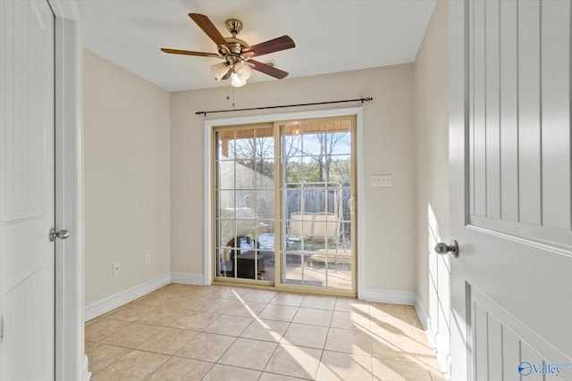 tiled empty room with ceiling fan