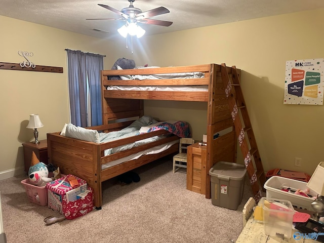 bedroom featuring ceiling fan, a textured ceiling, and carpet flooring