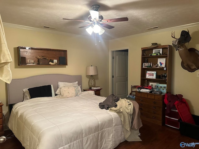 bedroom featuring ceiling fan, crown molding, dark hardwood / wood-style floors, and a textured ceiling