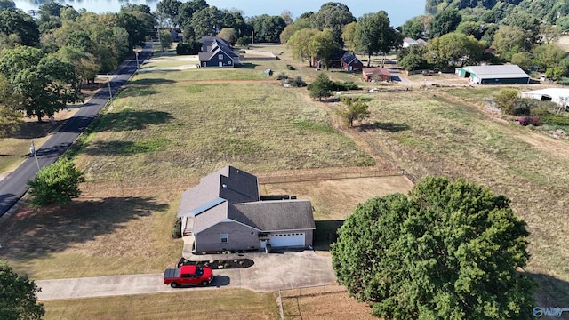 birds eye view of property with a rural view