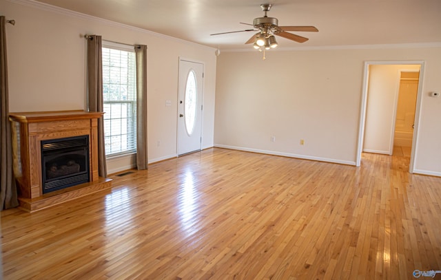 unfurnished living room featuring visible vents, a fireplace with raised hearth, a ceiling fan, ornamental molding, and light wood-style floors