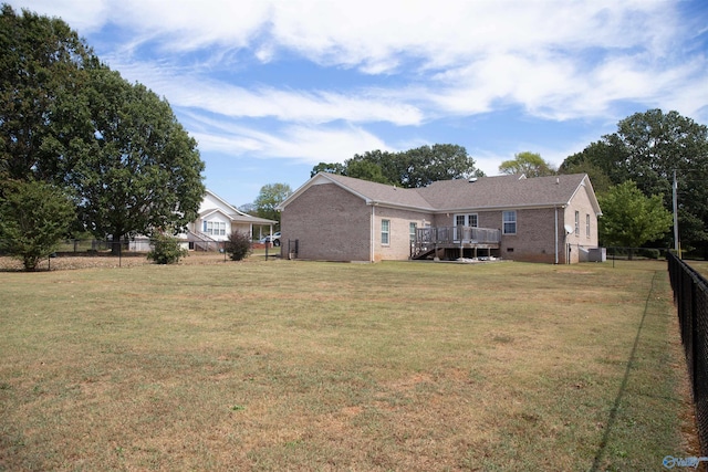 view of yard with fence and a deck