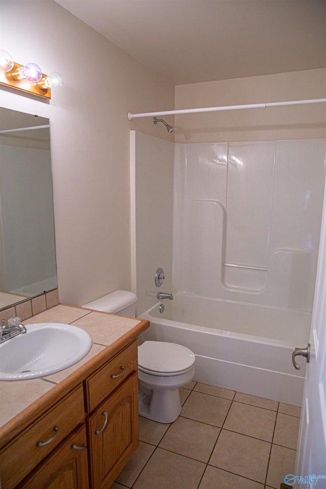 bathroom featuring  shower combination, vanity, toilet, and tile patterned floors