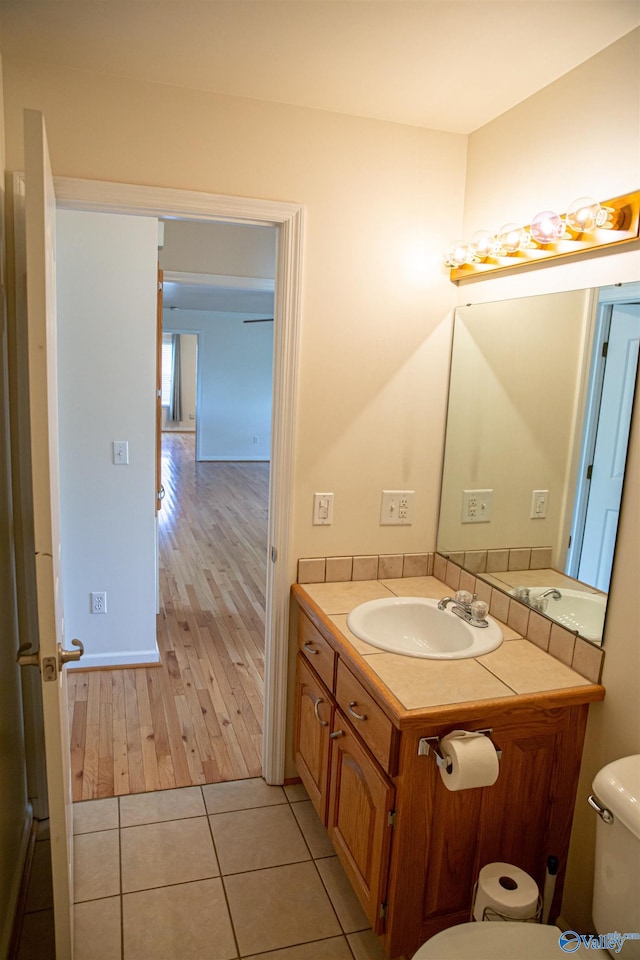 bathroom featuring toilet, vanity, and tile patterned floors