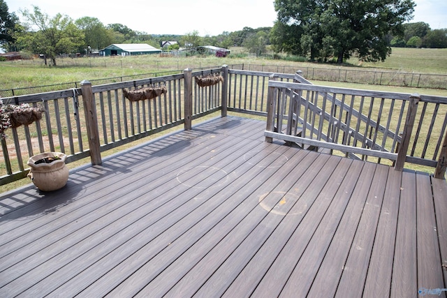 wooden deck featuring a fenced backyard and a rural view