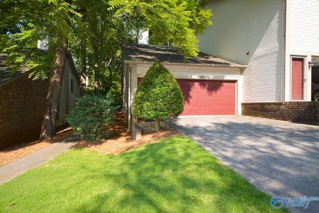 view of home's exterior featuring aphalt driveway, brick siding, and an attached garage