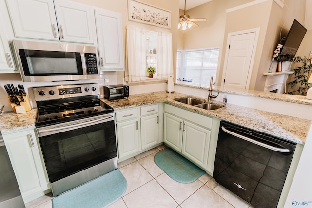 kitchen featuring sink, light tile patterned floors, kitchen peninsula, stainless steel appliances, and white cabinets