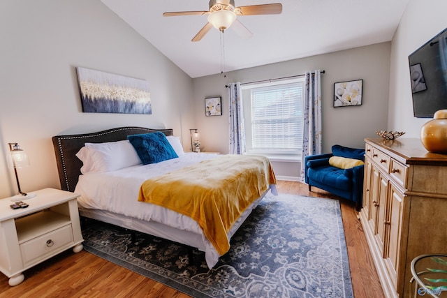 bedroom featuring lofted ceiling, ceiling fan, and light hardwood / wood-style flooring