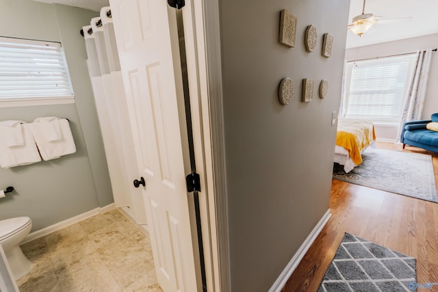 bathroom featuring hardwood / wood-style flooring, toilet, and a wealth of natural light