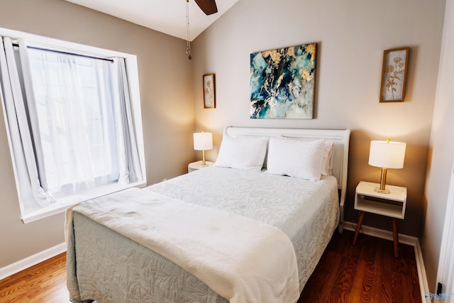 bedroom with hardwood / wood-style flooring, ceiling fan, and vaulted ceiling