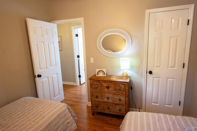 bedroom with dark hardwood / wood-style flooring