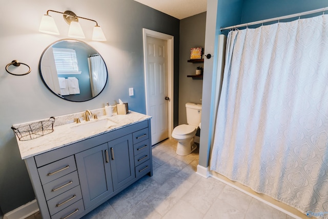 bathroom featuring vanity, toilet, and curtained shower