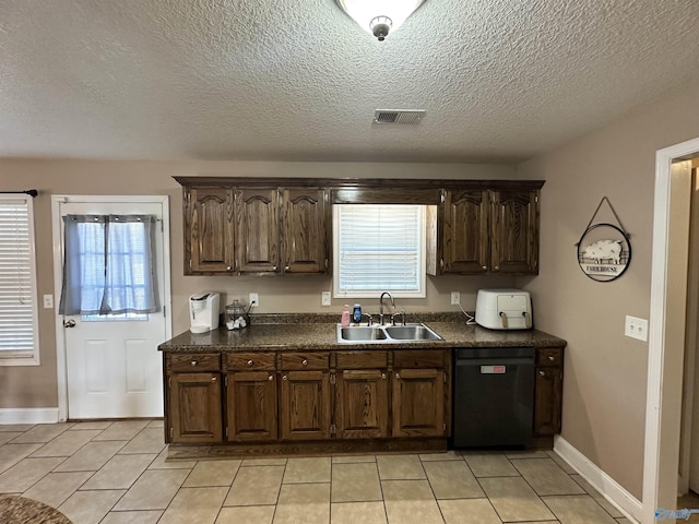 kitchen with sink, light tile patterned flooring, black dishwasher, a textured ceiling, and dark brown cabinets