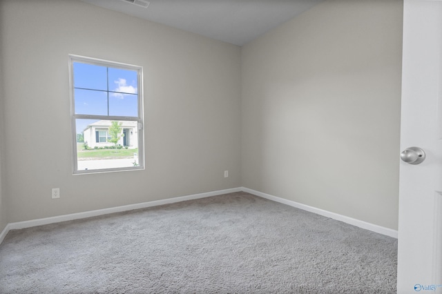 spare room with visible vents, baseboards, and carpet flooring