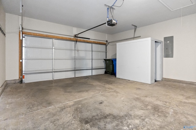 garage featuring electric panel, a garage door opener, and baseboards