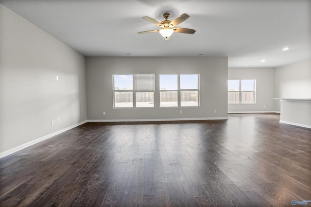 unfurnished living room with dark wood-style floors, recessed lighting, baseboards, and a ceiling fan