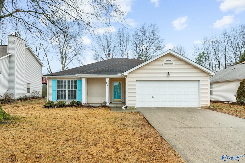 ranch-style home with a front lawn and a garage