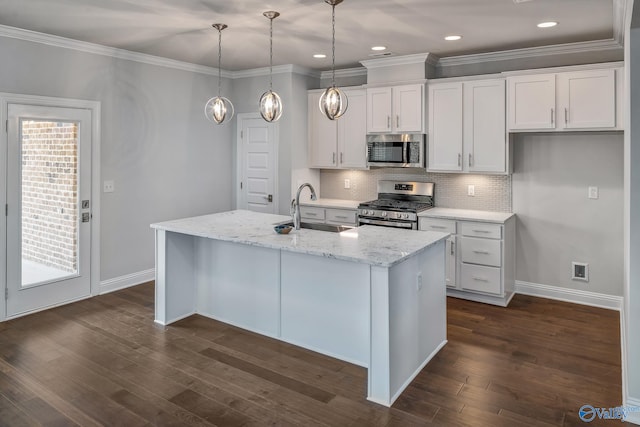 kitchen featuring stainless steel appliances, sink, a center island with sink, and white cabinets