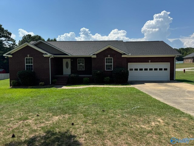 ranch-style house with a garage and a front yard