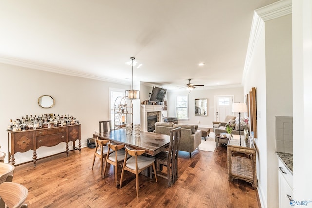 dining space featuring hardwood / wood-style flooring, ceiling fan, and ornamental molding