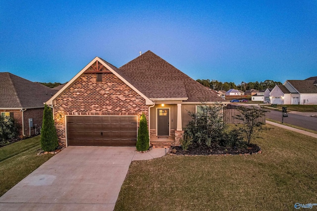 view of front of property featuring a front lawn and a garage