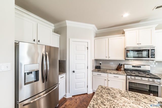 kitchen featuring white cabinets, decorative backsplash, light stone countertops, and appliances with stainless steel finishes