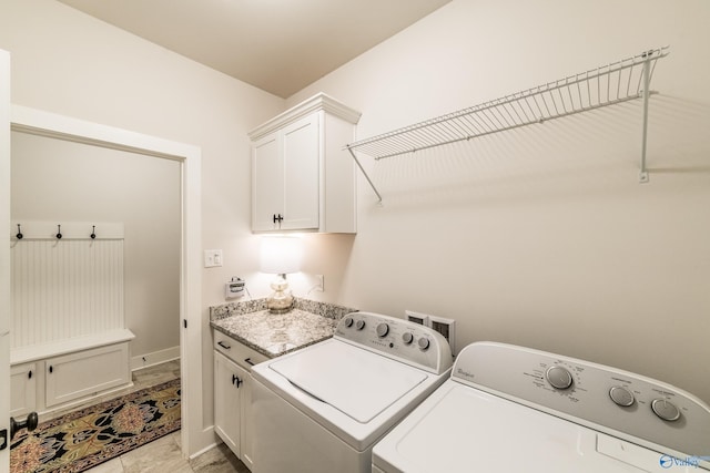 laundry room featuring separate washer and dryer, light tile patterned flooring, and cabinets