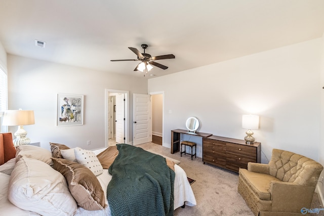 carpeted bedroom featuring ensuite bath and ceiling fan