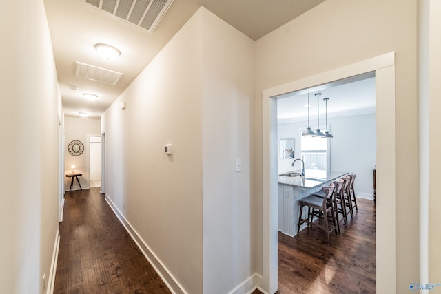 hallway with dark hardwood / wood-style flooring and sink