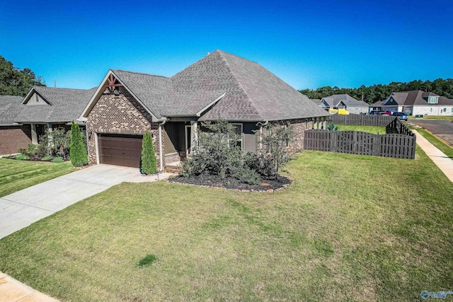 view of front of property with a garage and a front lawn