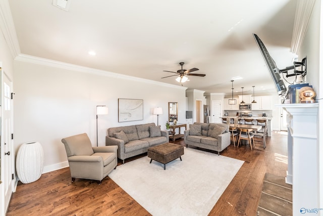 living room with ceiling fan, crown molding, and dark wood-type flooring