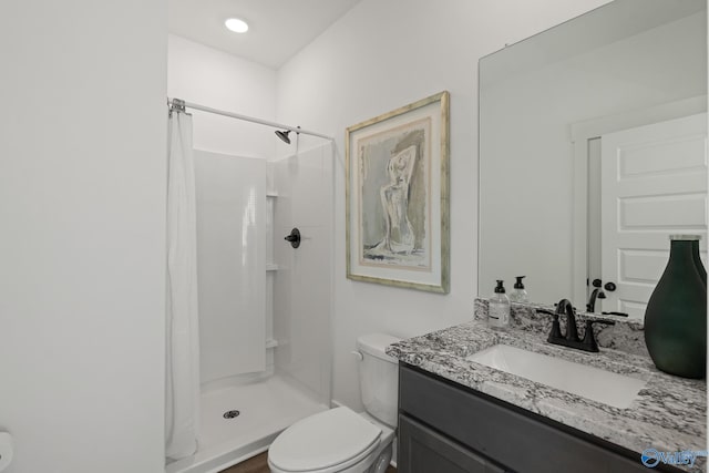 bathroom with vanity, toilet, and curtained shower