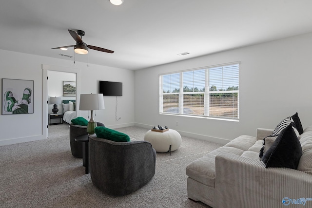 living room featuring ceiling fan and carpet