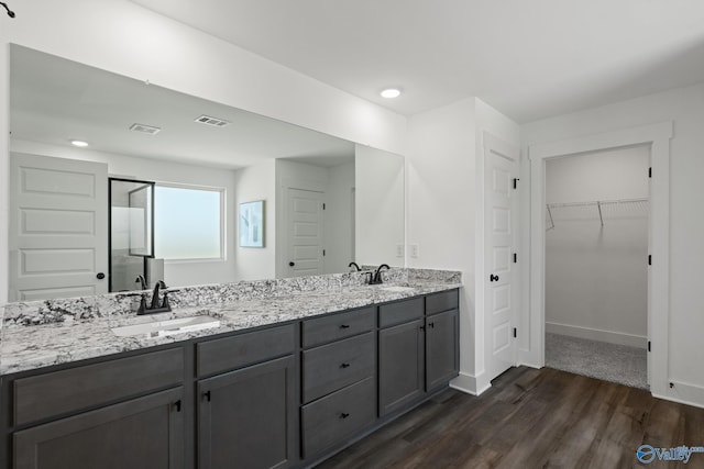 bathroom with a shower with door, wood-type flooring, and vanity